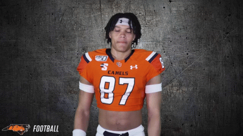a football player wearing an orange jersey with the number 87