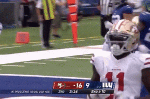 A Football Player Wearing Number 11 Stands On The Field During A Game GIF