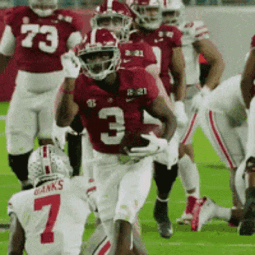 A Football Player Wearing Number 3 Is Running With The Ball GIF