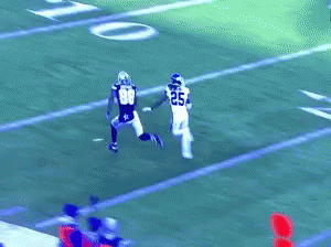 a football player wearing number 33 is trying to catch a pass