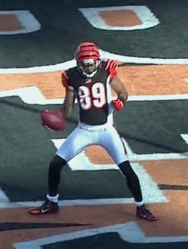 A Football Player Wearing Number 39 Is Holding A Football GIF