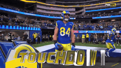 A Football Player Wearing Number 84 Stands On The Field GIF