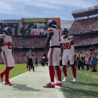 A Football Player Wearing Number 86 Stands On The Sidelines GIF