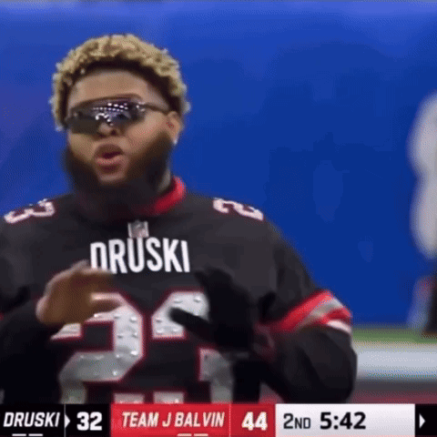 A Football Player Wearing Sunglasses And A Jersey That Says Druski GIF