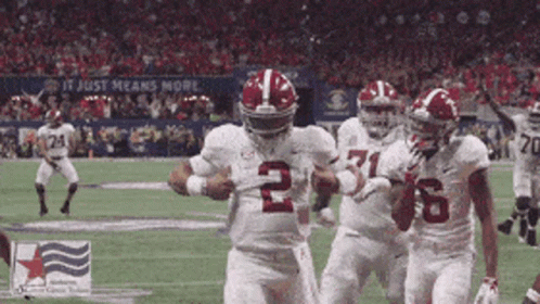 A Football Player Wearing The Number 2 Jersey Is Running With The Ball GIF