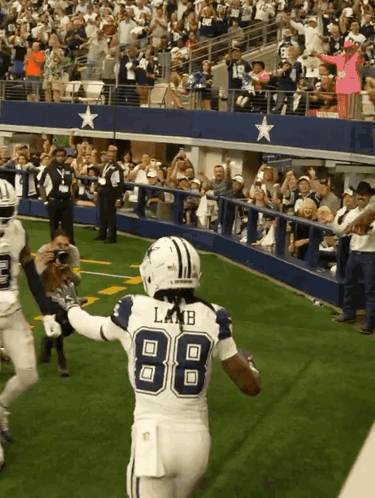 A Football Player Wearing The Number 88 Is Running On The Field GIF