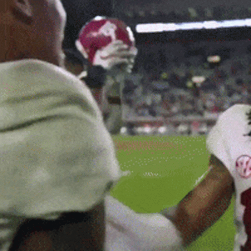 A Football Player With The Letter B On His Jersey Is Holding A Football GIF