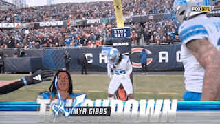 A Football Player With The Name Myr Gibbs On The Front GIF