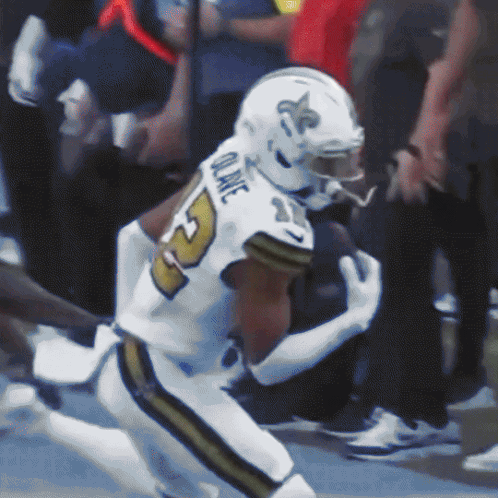 A Football Player With The Name Quake On The Back Of His Uniform GIF