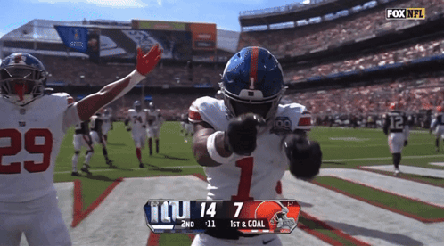 A Football Player With The Number 1 On His Helmet Stands On The Field GIF