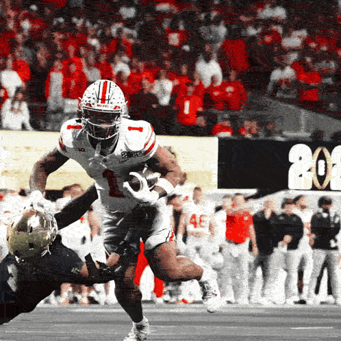 A Football Player With The Number 1 On His Jersey Is Being Tackled By Another Player GIF