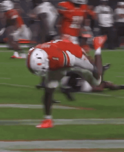 A Football Player With The Number 1 On His Jersey Is Doing A Handstand On The Field GIF