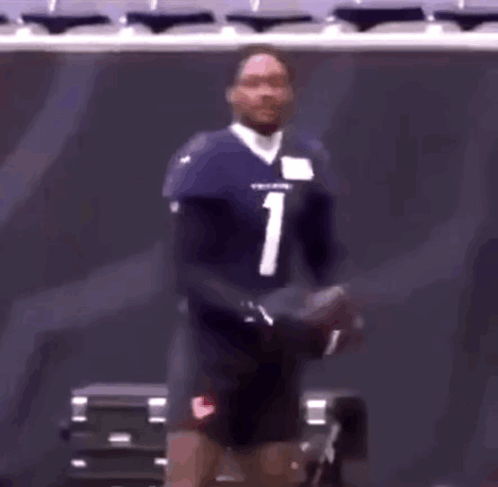 A Football Player With The Number 1 On His Jersey Is Standing In A Stadium GIF