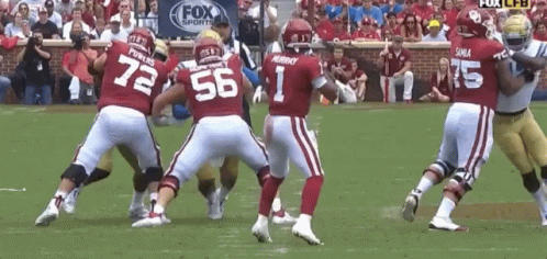 A Football Player With The Number 1 On His Jersey Is Surrounded By Other Players GIF