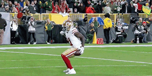 A Football Player With The Number 10 On His Jersey Is On The Field GIF
