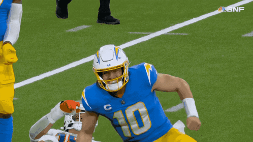 A Football Player With The Number 10 On His Jersey Is Running On The Field GIF