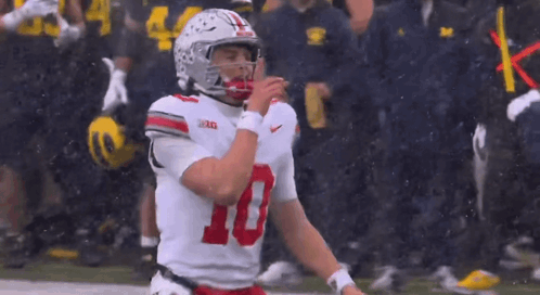 A Football Player With The Number 10 On His Jersey Is Standing On The Field GIF