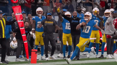 A Football Player With The Number 10 On His Jersey Runs On The Field GIF