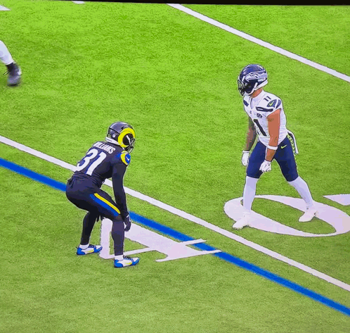 a football player with the number 11 on his jersey is jumping in the air