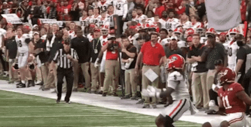 A Football Player With The Number 11 On His Jersey Is Running On The Field . GIF