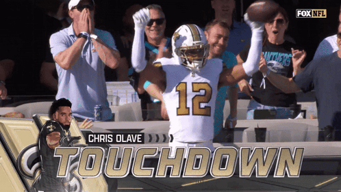 A Football Player With The Number 12 On His Jersey Celebrates GIF