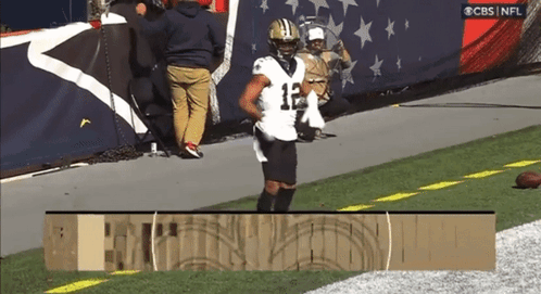 A Football Player With The Number 12 On His Jersey Is Running On The Field GIF