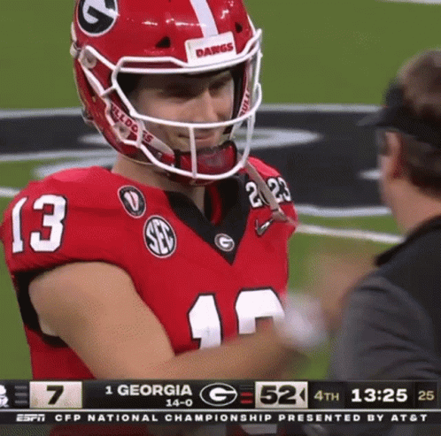 a football player with the number 13 on his jersey is talking to a referee .