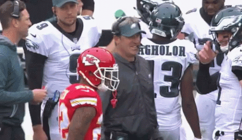 A Football Player With The Number 13 On His Jersey Talks To Another Player GIF