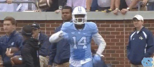 a football player with the number 14 on his jersey is running