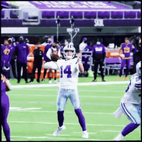 A Football Player With The Number 14 On His Jersey Throws A Pass GIF