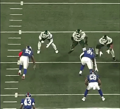 A Football Player With The Number 15 On His Jersey Is Being Tackled By Another Player . GIF
