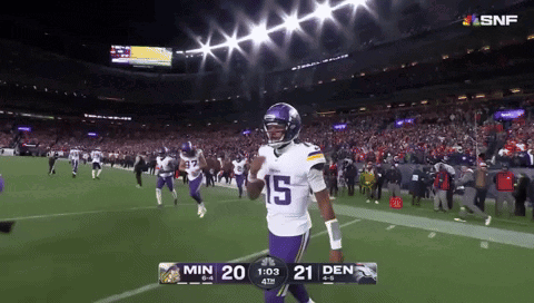 A Football Player With The Number 15 On His Jersey Walks Off The Field GIF
