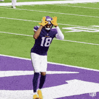 A Football Player With The Number 18 On His Jersey Is Running On A Field GIF
