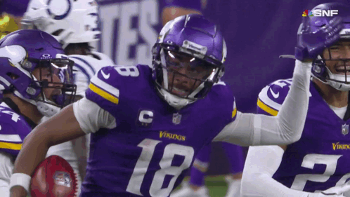 A Football Player With The Number 18 On His Jersey Is Running With The Ball GIF