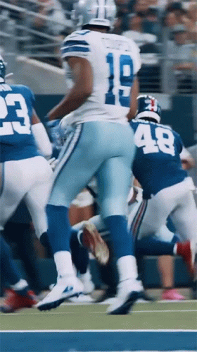 A Football Player With The Number 18 On His Jersey Runs On The Field GIF