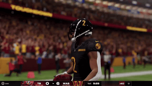 A Football Player With The Number 2 On His Helmet Stands On The Field GIF