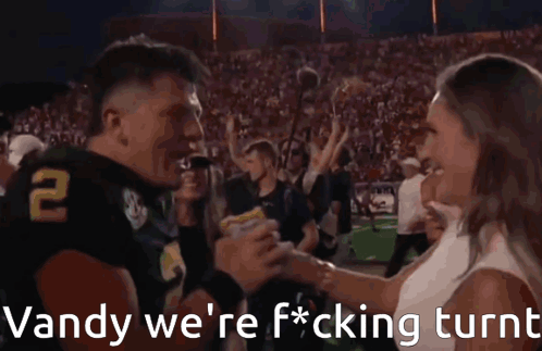 A Football Player With The Number 2 On His Jersey Is Being Interviewed By A Reporter GIF