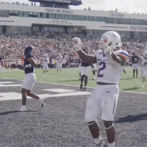 A Football Player With The Number 2 On His Jersey Stands On The Field GIF