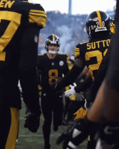 A Football Player With The Number 20 On His Helmet Is Talking To Another Player GIF