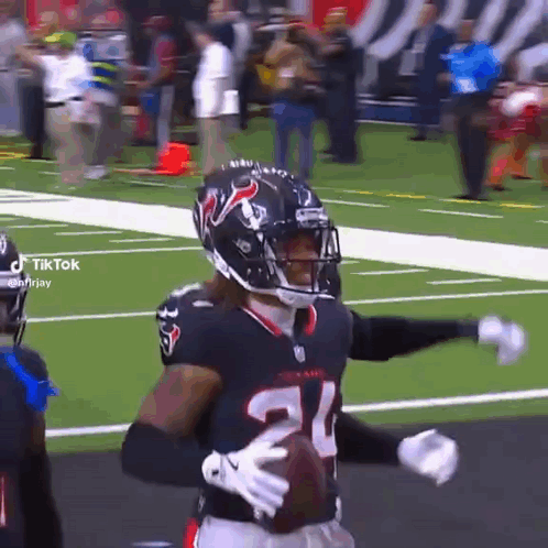 A Football Player With The Number 21 On His Jersey Holds A Football GIF