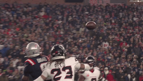 A Football Player With The Number 22 On His Jersey Catches The Ball GIF