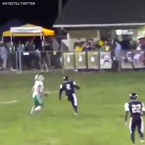 A Football Player With The Number 22 On His Jersey Is Running On The Field GIF