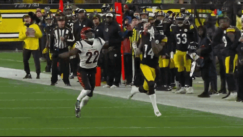 A Football Player With The Number 22 On His Jersey Runs On The Field GIF