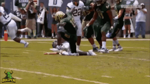 A Football Player With The Number 23 On His Jersey Is Kneeling On The Field GIF