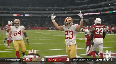 A Football Player With The Number 23 On His Jersey Stands On The Field GIF