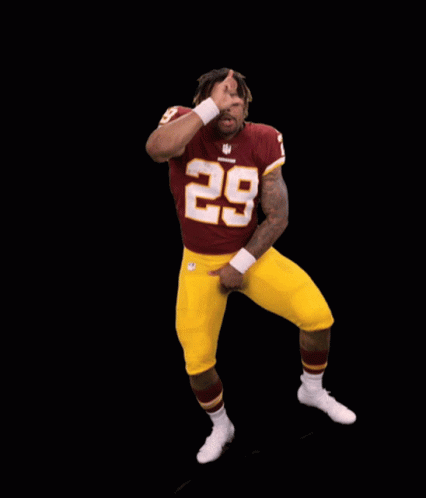 A Football Player With The Number 28 On His Jersey Is Dancing GIF