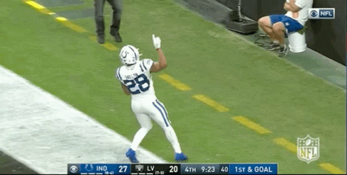 A Football Player With The Number 28 On His Jersey Stands On The Field GIF