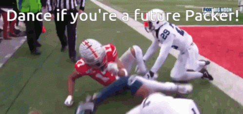 A Football Player With The Number 29 On His Jersey Is Being Tackled By Another Player GIF