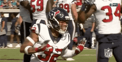 A Football Player With The Number 32 On His Jersey Is Running With The Ball . GIF