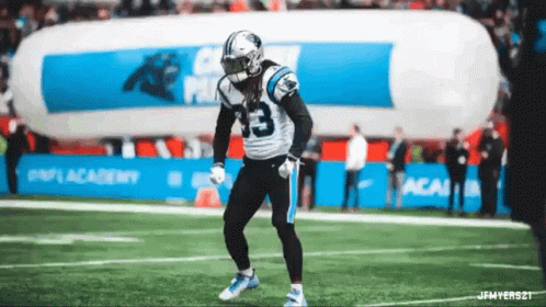 A Football Player With The Number 33 On His Jersey Is Dancing On The Field GIF